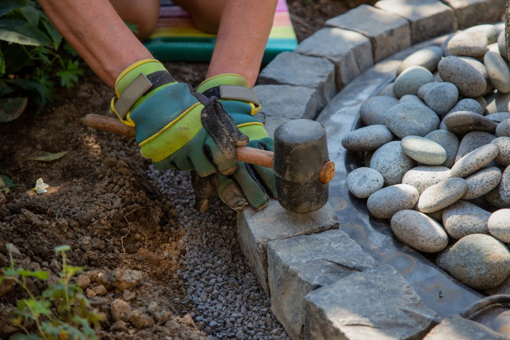 Hard Landscaping closeup shot of a handyman arranging cobblestones 2025 02 06 04 04 45 utc